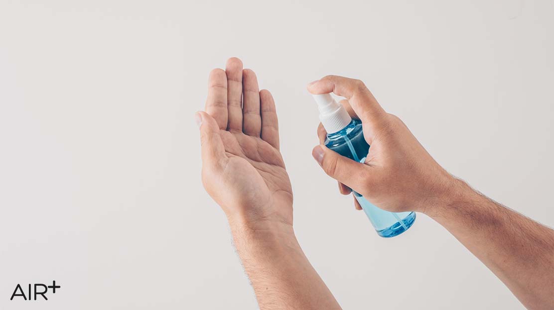 using hand sanitizer before putting face mask